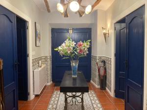 a vase of flowers on a table in a hallway at Casa Lucia in Caniles