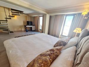 a bedroom with a large bed with pillows at SOFIA BOUTIQUE HOTEL in Kyrenia