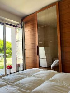 una camera da letto con un grande letto con una grande testiera in legno di La Terrazza Sul Lago a Ossuccio