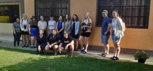 a group of people standing in front of a building at Runako Lodge in Arusha