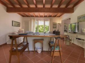 a kitchen with a large wooden table in a room at Incantevole villa full optional all'Isola d'Elba in Marina di Campo