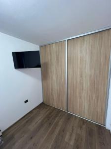 an empty room with a large wooden door at Sica GuestHouse in Borşa +1 photo