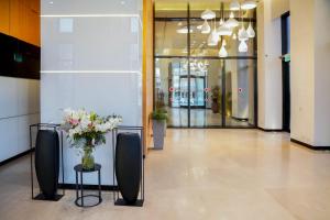 a lobby with a vase of flowers on a table at View of Paradise in Bat Yam