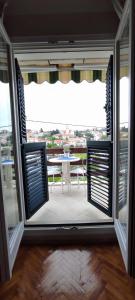 an open door to a balcony with a table at Studio Apartment Riva in Sumartin