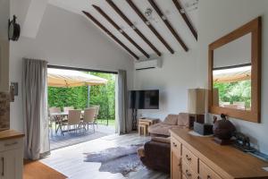 a living room with a couch and a television and a patio at VARNA KABAKUM HOUSE in Varna City