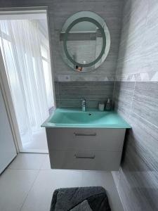 a bathroom with a sink and a mirror at Apartmán Lodenica in Piešťany
