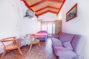 a living room with a couch and a table at Pristan Apartments in Dodoši