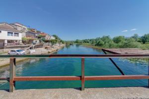 a view of a river from a bridge at Pristan Apartments in Dodoši