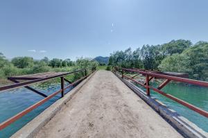 a bridge over a body of water at Pristan Apartments in Dodoši