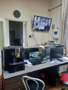 a desk with a computer and a laptop on it at Hun-Thor Szálláshely in Oroszlány