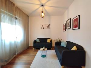 a living room with two couches and a table at Laranjal Guesthouse in Vila do Conde