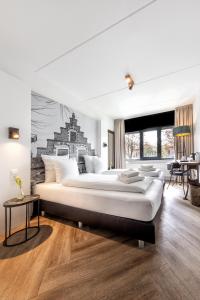 a bedroom with a large bed and a mural on the wall at Broeck Oudewater in Oudewater