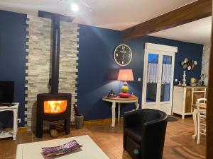 a living room with a wood stove in a room at La clé des champs in Acheux-en-Vimeu