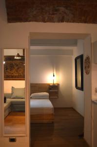 a bedroom with a bed and a light on the wall at Suite The Brick in Turin
