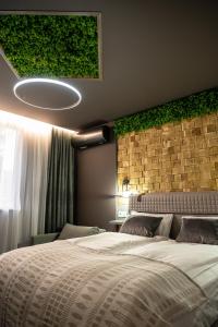 a bedroom with a large bed and a brick wall at Какао Апартамент Велинград in Velingrad