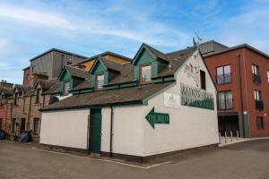 a building with a group of houses on top of it at Aldo's Place in Dingwall