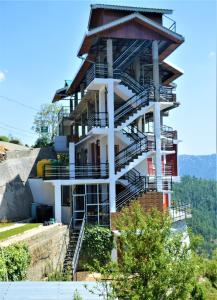 a building with stairs on top of a mountain at Ridhi Sidhi cottage in Kīar