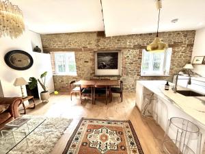 a kitchen and living room with a wooden table at Petworth Cottage-Sleeps 6-Pet Friendly-Central in Petworth