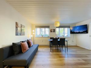 a living room with a couch and a table at aday - Charming apartment in the pedestrian street of Frederikshavn in Frederikshavn