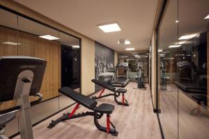 - une rangée de vélos d'exercice dans une salle de sport avec des miroirs dans l'établissement Hotel Gorinchem, à Gorinchem