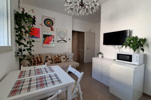 a living room with a table and a couch at Appartamento al mare in Pesaro