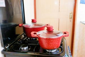 two pots sitting on top of a stove at Tiamcy homes in Kisumu