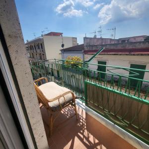 a chair sitting on the balcony of a building at Sole raggiante Lia Darzillo in Afragola