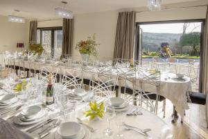 a long dining room with a long table with glasses at Get-Togethers with function room in Little Dean