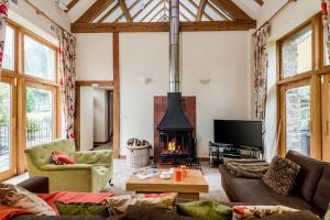 a living room with a couch and a fireplace at Get-Togethers with function room in Little Dean