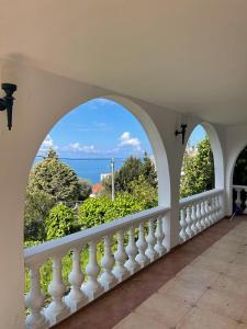 a balcony with two arches and a view of the ocean at Villa Marina in Dobra Voda