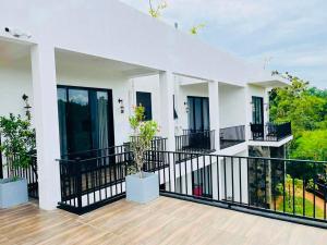 a balcony of a house with black railing at Black Mustang Hotel in Dambulla