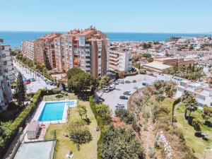 arial view of a city with a swimming pool and buildings at Mikasika - Duplex Apartment with seasonal swimming pool & walking distance from the beach in Cala del Moral