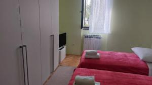 a small room with a bed and a tv at Iva in Zadar