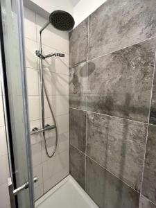 a shower with a glass door in a bathroom at Forest Villa, Kaatsheuvel in Loon op Zand