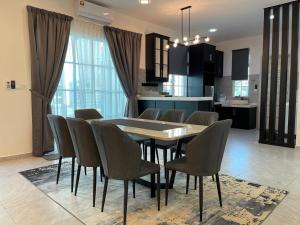 a dining room and kitchen with a table and chairs at De France Pool Villa Mu5lim Only in Malacca