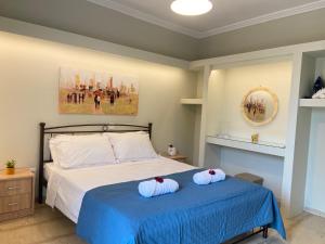 a bedroom with a bed with two pillows on it at Adriana's Summer House in Kassiopi