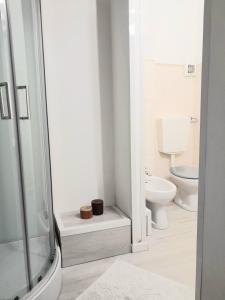 a white bathroom with a toilet and a shower at Da Julia in Oristano