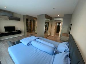 a bedroom with a bed with blue pillows at Townhouse near Donmuang airport 4 bedrooms in Bangkok