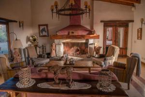 a living room with a fireplace and a table at Posada Rural La Matilde in San Javier