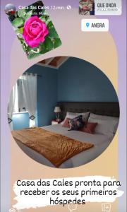 a poster of a bedroom with a bed with a flower at Casa das Cales in Angra do Heroísmo