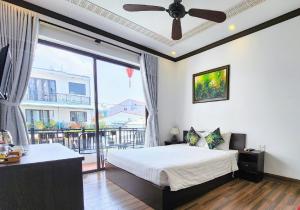 a bedroom with a bed and a large window at Vincent's House in Hoi An