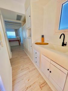 a kitchen with white cabinets and a sink at Apartments enosis, Poseidon in Agia Anna Naxos