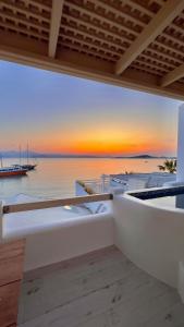 a view of the ocean from the balcony of a house at Apartments enosis, Poseidon in Agia Anna Naxos