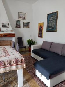 a living room with a couch and a table at Su Cuile historical country house with barbecue in Martis