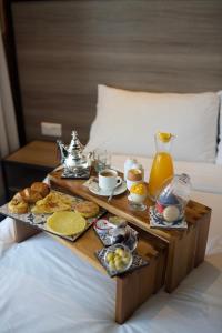 a tray of breakfast foods on a bed at ONOMO Hotel Tanger Med in Tangier