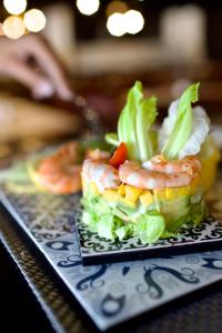 a plate of food with shrimp and lettuce on a table at ONOMO Hotel Tanger Med in Tangier