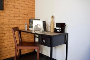 a black desk with a laptop and a chair at ONOMO Hotel Tanger Med in Tangier