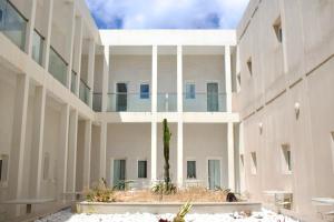 a rendering of a building with a palm tree in the courtyard at ONOMO Hotel Tanger Med in Tangier