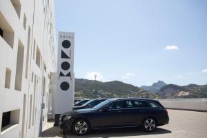 a car parked in a parking lot next to a building at ONOMO Hotel Tanger Med in Tangier