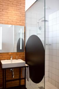 a bathroom with a sink and a shower at ONOMO Hotel Tanger Med in Tangier